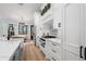 Gourmet kitchen featuring custom cabinets, island, stainless appliances, and stylish backsplash at 25305 83Rd E Ave, Myakka City, FL 34251