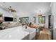 Bright and airy open-concept kitchen boasts a large island with a farmhouse sink and modern lighting at 25305 83Rd E Ave, Myakka City, FL 34251