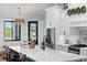 Bright kitchen with an island, stainless steel appliances, white cabinets, and an ornate backsplash at 25305 83Rd E Ave, Myakka City, FL 34251