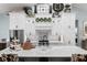 Bright kitchen boasts stylish backsplash, an island with seating, and modern appliances at 25305 83Rd E Ave, Myakka City, FL 34251