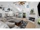 Bright living room with fireplace, vaulted ceiling, and open concept kitchen/dining area at 25305 83Rd E Ave, Myakka City, FL 34251