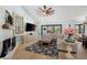 Open-concept living room with hardwood floors, fireplace, and lots of natural light at 25305 83Rd E Ave, Myakka City, FL 34251