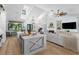 Open-concept living space featuring modern kitchen, fireplace, and comfortable seating area at 25305 83Rd E Ave, Myakka City, FL 34251