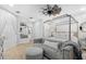 Bright main bedroom with a four-poster bed, neutral decor, and modern ceiling fan at 25305 83Rd E Ave, Myakka City, FL 34251