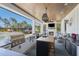 An amazing outdoor kitchen features a grill, island, fireplace, and a large pass-through window to the exterior at 25305 83Rd E Ave, Myakka City, FL 34251