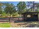 Spacious pasture with mature trees and a well-maintained wooden shelter at 25305 83Rd E Ave, Myakka City, FL 34251
