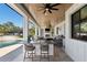 Well-appointed outdoor kitchen and bar area with a grill, seating, and a view of the pool and backyard at 25305 83Rd E Ave, Myakka City, FL 34251