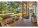 Inviting porch features wood flooring, a swing, and a 'welcome' sign creating a relaxing outdoor space at 25305 83Rd E Ave, Myakka City, FL 34251
