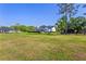 Wide shot of the property featuring a modern farmhouse, RV, and pasture, showcasing the expansive grounds at 25305 83Rd E Ave, Myakka City, FL 34251