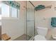 Bright bathroom featuring a tiled walk-in shower, stool, and colorful window valance at 2708 Fort Worth St, Sarasota, FL 34231