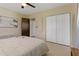 Bedroom with a closet, neutral tones, ceiling fan, and simple coastal artwork at 2708 Fort Worth St, Sarasota, FL 34231