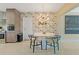 Dining area with unique wallpaper, modern light fixture, and seating for four at 2708 Fort Worth St, Sarasota, FL 34231