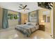 Comfortable main bedroom with a ceiling fan, two large windows, and neutral decor at 2708 Fort Worth St, Sarasota, FL 34231