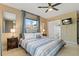 Main bedroom with ceiling fan, closet with mirrored door, and TV at 2708 Fort Worth St, Sarasota, FL 34231