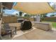 Relaxing outdoor patio shaded by a large awning, featuring a chair, grill, and convenient outdoor storage at 2708 Fort Worth St, Sarasota, FL 34231
