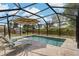 Stunning screened-in pool with lounging chairs and umbrella, creating a relaxing outdoor oasis at 2708 Fort Worth St, Sarasota, FL 34231