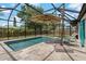 Relaxing screened-in pool area complete with lounge chairs, an umbrella, and a refreshing pool at 2708 Fort Worth St, Sarasota, FL 34231