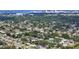 Expansive aerial view of a charming neighborhood with lush greenery and stunning cityscape backdrop at 2932 Upper Tangelo Dr, Sarasota, FL 34239