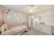 Bright bedroom featuring a red metal bed frame, soft carpet, and a white dresser, creating a serene and cozy space at 2932 Upper Tangelo Dr, Sarasota, FL 34239