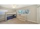 Cozy bedroom with carpet, a bunk bed, a storage unit and a window offering a view at 2932 Upper Tangelo Dr, Sarasota, FL 34239