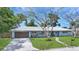 Charming one story home with beautiful yard, light blue exterior, and mature trees at 2932 Upper Tangelo Dr, Sarasota, FL 34239