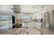 Kitchen with stainless steel appliances, white cabinets, granite countertops, and a view from the window at 2932 Upper Tangelo Dr, Sarasota, FL 34239