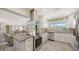 Beautiful kitchen with stainless steel appliances, granite countertops, and open floor plan to the living room at 2932 Upper Tangelo Dr, Sarasota, FL 34239