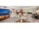 Open-concept living room with stylish decor, tile flooring and bar seating at kitchen counter at 2932 Upper Tangelo Dr, Sarasota, FL 34239