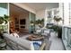 Inviting condo balcony with plush seating, sliding doors to interior, and exterior plants for privacy at 301 Quay Commons # 503, Sarasota, FL 34236
