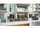 Relaxing balcony with sleek glass railings and stylish furniture, perfect for enjoying outdoor living at 301 Quay Commons # 503, Sarasota, FL 34236