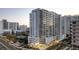 Close exterior shot featuring a modern condo building with street-level commercial space and lush landscaping at 301 Quay Commons # 503, Sarasota, FL 34236