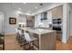 Modern kitchen featuring a large island with seating, stainless steel appliances, and sleek cabinetry at 301 Quay Commons # 503, Sarasota, FL 34236