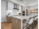 Bright kitchen with a large island, modern appliances, white cabinets, and bar-style seating at 301 Quay Commons # 503, Sarasota, FL 34236
