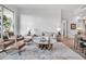 Bright living room with modern furniture, a unique coffee table, and contemporary decor at 301 Quay Commons # 503, Sarasota, FL 34236