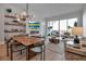 Open-concept living area features a dining table, modern lighting, fireplace and large windows with city views at 301 Quay Commons # 503, Sarasota, FL 34236
