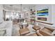 Elegant living room featuring stylish furniture, a modern fireplace, hardwood floors, and large windows at 301 Quay Commons # 503, Sarasota, FL 34236