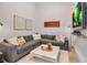 Cozy living room with a large sectional sofa, modern decor, and a TV at 301 Quay Commons # 503, Sarasota, FL 34236