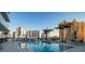 Beautiful rooftop pool with city views, lounge seating, and palm trees at 301 Quay Commons # 503, Sarasota, FL 34236
