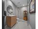 Contemporary bathroom featuring wood vanity, round mirror, and glass shower with modern fixtures at 301 Quay Commons # 611, Sarasota, FL 34236