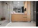Elegant bathroom with a glass shower, wood vanity, and contemporary design elements throughout at 301 Quay Commons # 611, Sarasota, FL 34236