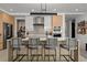 Well-equipped modern kitchen with island seating, stainless steel appliances, and stylish lighting at 301 Quay Commons # 611, Sarasota, FL 34236