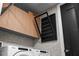Close up of the black folding rack in the laundry room next to the sleek wooden cabinets and appliances at 301 Quay Commons # 611, Sarasota, FL 34236