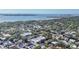 Extensive aerial view of a commercial property near water, nestled amongst trees, offering a serene setting at 3350 S Osprey Ave # 211A, Sarasota, FL 34239