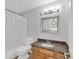 Bright bathroom with a granite countertop vanity and shower/tub combination at 3350 S Osprey Ave # 211A, Sarasota, FL 34239