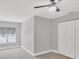 Carpeted bedroom featuring a ceiling fan, window, and a closet with sliding doors at 3350 S Osprey Ave # 211A, Sarasota, FL 34239