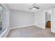 Bedroom with carpet flooring and a window, next to a doorway leading to the bathroom at 3350 S Osprey Ave # 211A, Sarasota, FL 34239