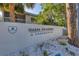 The Oasis on Osprey condominium community sign with lush trees at 3350 S Osprey Ave # 211A, Sarasota, FL 34239