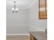 Bright dining area featuring neutral tones, a classic chandelier, and granite countertops at 3350 S Osprey Ave # 211A, Sarasota, FL 34239