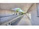 Inviting hallway with natural light, showcasing well-maintained architecture and outdoor plants at 3350 S Osprey Ave # 211A, Sarasota, FL 34239