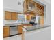 Bright kitchen with granite counters, stainless steel appliances and wood cabinetry with dining bar at 3350 S Osprey Ave # 211A, Sarasota, FL 34239